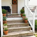Wooden outdoor steps leading up to a front porch